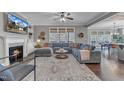 Comfortable living room with fireplace, built-in shelves, large sectional sofa, and beautiful hardwood floors at 205 Virginia Water Dr, Rolesville, NC 27571