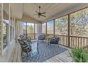 Cozy screened-in porch with wicker seating, ceiling fan, and scenic views of the outdoors at 205 Virginia Water Dr, Rolesville, NC 27571