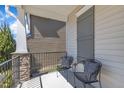 Inviting porch with stone pillars and black wrought iron chairs and railings for relaxing at 205 Virginia Water Dr, Rolesville, NC 27571