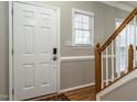 Welcoming entryway with hardwood floors, neutral paint, and a staircase with wooden banister at 2301 Lemuel Dr, Raleigh, NC 27615