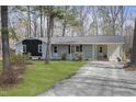 Well-kept ranch-style home with a fresh exterior and gravel driveway at 2312 Valley Rd, Sanford, NC 27330