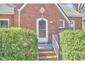 Close-up of the front door with a wreath and decorative window at 2313 Prince St, Durham, NC 27707