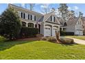 Charming two-story home with a two-car garage and a well-maintained, professionally landscaped front yard at 233 Candia Ln, Cary, NC 27519