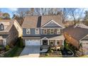 Charming two-story home with a covered front porch, brick and stone accents, and a well-manicured front yard at 234 Macallan Dr, Burlington, NC 27215