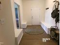 Welcoming foyer featuring built-in bench seating, a round rug, and access to other rooms in the home at 2575 Sheriff Watson Rd, Sanford, NC 27332