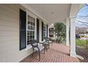 Inviting covered front porch features brick flooring and ample room for seating at 2803 Cameron Pond Dr, Cary, NC 27519