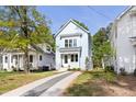 Charming two-story home featuring a well-manicured lawn, a modern white door, and lovely curb appeal at 2816 Cascadilla St, Durham, NC 27704