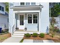 Charming entryway with a welcoming porch, lush greenery, and stylish fixtures at 2816 Cascadilla St, Durham, NC 27704