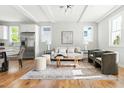 Bright living area featuring hardwood floors, modern furniture, and ample natural light, perfect for relaxation and entertainment at 2816 Cascadilla St, Durham, NC 27704