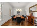 Elegant dining room with hardwood floors, chandelier, and large table for gatherings at 3204 Cobblestone Ct, Raleigh, NC 27607