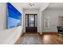 Inviting entryway with dark wood door, striking painting, hardwood floors and stylish rug at 3204 Cobblestone Ct, Raleigh, NC 27607