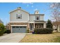 Charming two-story home featuring stone accents, a covered porch, and a well-manicured lawn at 3609 Kilgo Dr, Durham, NC 27705
