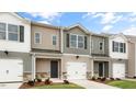 Exterior facade of townhomes with neutral color schemes, single garages, and manicured lawns at 42 Sweet Meadow Rd, Angier, NC 27501