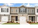 A row of newly constructed townhomes showcases various colors and textures on the exterior at 46 Sweet Meadow Rd, Angier, NC 27501