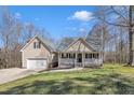 Charming two-story home featuring a front porch and attached two-car garage at 484 Galaxy Dr, Garner, NC 27529