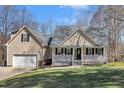 Charming two-story home with front porch and a well-manicured lawn at 484 Galaxy Dr, Garner, NC 27529