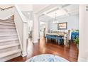 Bright dining room with wood floors, chandelier lighting, and a view of the living area at 50 Lockamy Ln, Youngsville, NC 27596