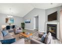 Open-concept living room featuring a fireplace, vaulted ceiling, and contemporary decor at 509 High Ridge Dr, Durham, NC 27707