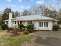 Attractive white brick home with a red front door, and landscaped front yard at 513 N Nash St, Hillsborough, NC 27278