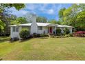 A beautifully landscaped front yard is showcased in this photograph, featuring mature bushes and a freshly cut lawn at 513 N Nash St, Hillsborough, NC 27278