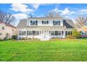 Elegant two-story home features black shutters and a lush, green lawn under a bright sky at 518 Parkview Dr, Burlington, NC 27215