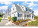 View of the well-maintained home with a detached garage, manicured landscaping, and charming curb appeal at 518 Parkview Dr, Burlington, NC 27215