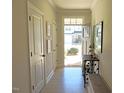 Bright entryway with white walls, light wood floors, and a view to the front door at 519 Flat Ford Rd, Hillsborough, NC 27278