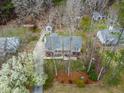Aerial view of a single story home with a landscaped front yard and mature trees in a residential neighborhood at 5216 Passenger Pl, Raleigh, NC 27603