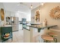 Bright kitchen featuring stainless steel appliances, granite countertops, and bar seating at 527 N Main St, Wake Forest, NC 27587