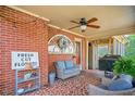 Cozy, tiled porch with stylish furniture, a ceiling fan, and decorative accents at 527 N Main St, Wake Forest, NC 27587