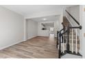 Open-concept living space featuring modern wood floors and staircase leading to the upper level at 5421 Vista View Ct, Raleigh, NC 27612