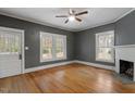 Spacious living room with hardwood floors, a ceiling fan, and a fireplace at 5505 Farrington Rd, Chapel Hill, NC 27517