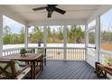 Relaxing screened-in porch with ceiling fan, dining table, and views of the backyard at 562 Boulder Point Dr, Chapel Hill, NC 27516