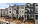 A row of new townhomes showcases diverse exterior colors and designs with landscaped front yards and walkways at 6351 Perry Creek Rd, Raleigh, NC 27616