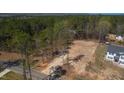 A cleared lot is ready for construction among wooded land with other neighborhood homes nearby at 680 Jasmine Rd, Fuquay Varina, NC 27526