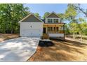 Inviting two-story home with a two-car garage, green front yard, and a welcoming entrance at 680 Jasmine Rd, Fuquay Varina, NC 27526