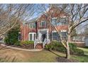 Classic two-story red brick home with a well-maintained lawn and inviting front porch at 7 Starwood Ln, Durham, NC 27712