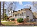 Quaint two-story home with a welcoming front porch and manicured landscaping at 817 Roanoke Dr, Cary, NC 27513