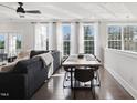 Well-lit living area with a sectional sofa, ceiling fan, and large windows offering plenty of natural light at 10320 Sablewood Dr # 107, Raleigh, NC 27617