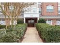 Beautiful building entrance with meticulously maintained landscaping, with inviting entry doors and architectural details at 10511 Rosegate Ct # 203, Raleigh, NC 27617