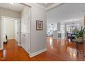 Open-concept living space featuring hardwood floors, fireplace, dining area with chandelier, and comfortable seating at 10511 Rosegate Ct # 203, Raleigh, NC 27617