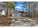 Lovely single-story home with a two-car garage and a concrete driveway surrounded by mature trees at 1107 Goldendale Dr, Durham, NC 27703