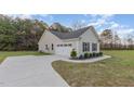 Features a spacious two car garage and extra long driveway with manicured landscaping at 11771 Raleigh Rd, Four Oaks, NC 27524