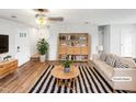 Inviting living room with hardwood floors, a ceiling fan, and ample natural light at 1205 Bent Willow Dr, Durham, NC 27704