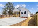 Quaint home showcasing a covered porch and well-maintained landscaping at 1335 Elrado St, Burlington, NC 27217