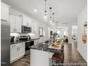 Modern kitchen features white cabinets, black granite countertops, and stainless steel appliances at 141 N District Ave # 295, Clayton, NC 27527