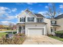 Beautiful two-story home featuring white siding, green shutters, and an attached garage at 1968 Shadow Glen Dr, Raleigh, NC 27604