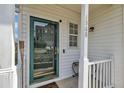Inviting front entrance with a green door, a side bench, and house number 1968 at 1968 Shadow Glen Dr, Raleigh, NC 27604