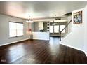 Spacious living room with gleaming hardwood floors, neutral paint, lots of windows, and an open floor plan at 204 Hillview Dr, Durham, NC 27703