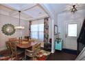 Inviting dining room featuring a coffered ceiling, stylish lighting, and an elegant table setting at 2144 Waterview Dr, Graham, NC 27253